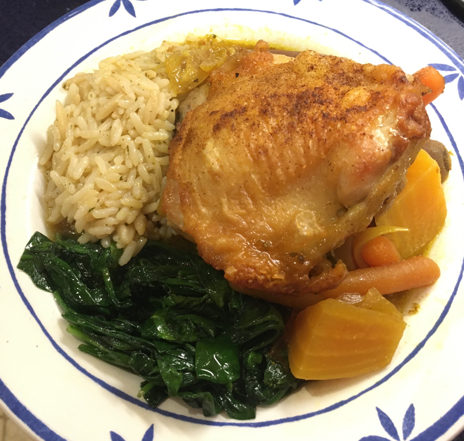 Picture of plated braised chicken with carrots, onions, beets, spinach and rice pilaf